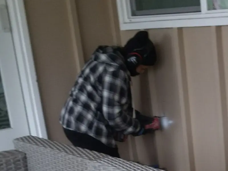 Professional electrician installing an exterior outlet in Rowley
